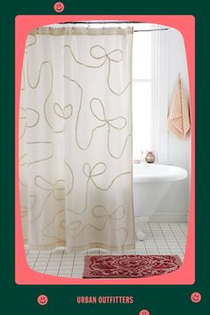 a bathroom with a shower curtain and rug on the floor next to a bathtub