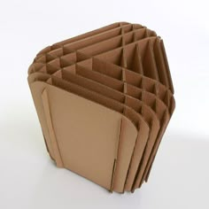 a stack of folded brown paper sitting on top of a white table