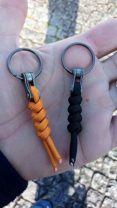 two key chains attached to each other in the palm of a person's hand