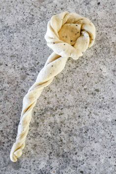 a twisted piece of bread on the ground