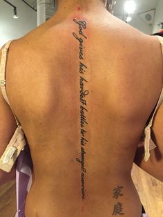 the back of a woman's body with writing on it