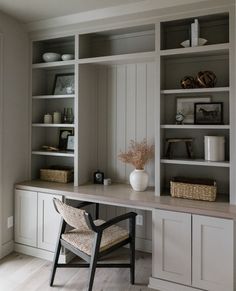 a white desk and some shelves in a room