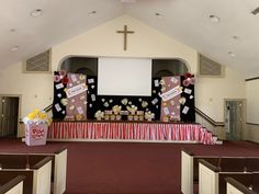 an empty church with red carpet and white walls, decorated for a birthday party or other special occasion