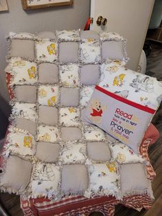 winnie the pooh crib blanket and pillow set on a chair in a living room