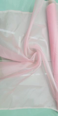 a roll of pink tissue sitting on top of a plastic bag