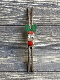 a pair of wooden skis decorated with holly leaves and a red nose