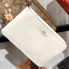 Coach Corner Zip Wristlet Chalk Leather Color: Gold / Chalk Signature Coated Canvas With Crossgrain Gold Logo Two Credit Card Slots Zip-Top Closure, Fabric Lining Wrist Strap Attached 6 1/4" (L) X 4" (H) X 1/2" (W) Compact White Bag For Daily Use, Elegant Coach Pouch For Everyday, Elegant Everyday Coach Pouch, Cream Coin Purse For Daily Use, Classic White Rectangular Clutch, Elegant Compact Coach Bag, Elegant White Clutch With Zipper Closure, Elegant White Travel Pouch, White Coach Clutch With Zipper Pouch