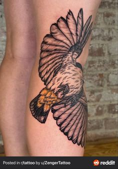 an eagle tattoo on the side of a woman's leg