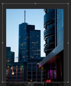 the city skyline is lit up at night, with skyscrapers in the background and lights on