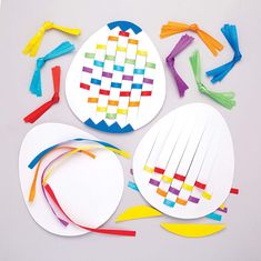 paper plate crafts with colored strips and scissors on white table top, next to each other