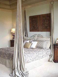 an image of a bedroom setting with four poster bed in the middle and two nightstands on either side