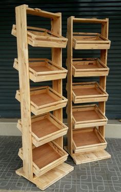 two wooden shelvings sitting next to each other on top of a cement floor