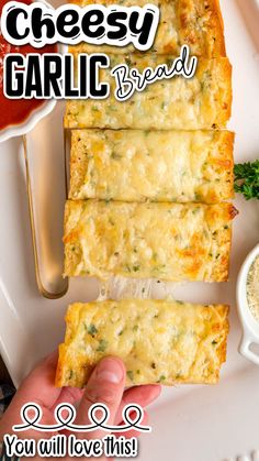 someone is holding up some cheesy garlic bread on a plate with dipping sauce