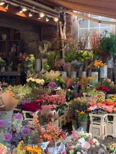 a flower shop filled with lots of colorful flowers