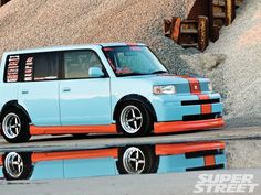 a blue van parked next to a pile of dirt