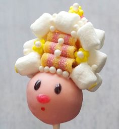 a close up of a toy head with food on it's head and hair