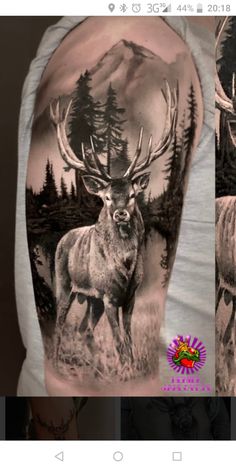 a man's arm with an image of a deer and pine trees on it