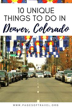 cars parked on the side of a road with flags flying in the air above them