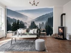 a living room filled with furniture and a fire place in front of a wall mural