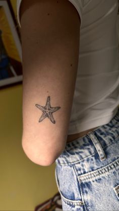 a woman with a starfish tattoo on her arm