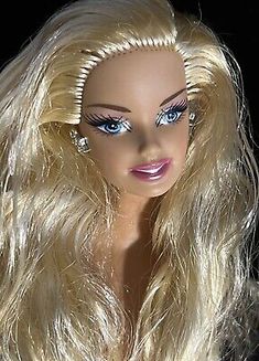 a blonde doll with long hair and blue eyes