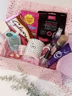 a pink box filled with lots of beauty products