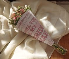 a bouquet of flowers laying on top of a white sheet with the words happy new year written on it