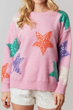 The cutest and softest sweater! We are obsessed over this color combo! Bubblegum pink sweater with orange, purple and aqua sequin embellished stars. Round neckline and cuffs with ribbed hem. Oversized fit. 100% polyester Galaxy Sweater, Diy Christmas Outfit, Pastel Sweater, Unicorn Fashion, Pink Galaxy, Trendy Sweaters, Star Sweater, Classic Sweater, Long Sleeve Sequin