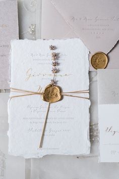 the wedding stationery is laid out on top of each other