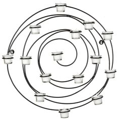 a spiral shaped candle holder with many candles in it