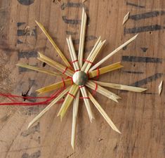 a clock made out of wooden sticks and string