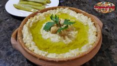 a bowl filled with mashed potatoes and garnished with parsley on top