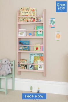 a child's book shelf with books on it and a stuffed animal next to it