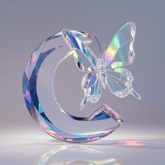 a crystal sculpture with a butterfly on it's back and the letter c in the middle