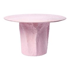 a pink table with a circular top on a white background in the shape of a vase