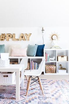 a white table sitting in front of a book shelf filled with books