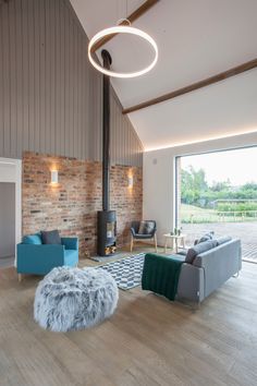 Contemporary Living Space with Black Vintage Stove Love the use two different texture on one wall. Rustic Living Room Designs, Vintage Stove, Farmhouse Living Room Decor, High Ceiling Living Room, Modern Rustic Living Room, Floor Renovation, Light Hardwood Floors