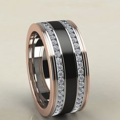 a black and white wedding ring with two rows of diamonds on the inside of it