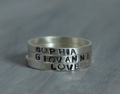 "Hand Stamped Jewelry - Sterling Silver Hand Stamped Ring - Personalized Name Ring Stacking Ring Stack one or Stack four! Customized with the name(s) or saying of your choosing! This listing is for one ring. Please change the quantity if you desire more than one. You can stack 3 to 4 of these rings comfortably. Each ring is hand stamped in my studio with the name(s) or saying of your choice. Letters have been oxidized black. Made from .925 sterling silver. Ring measures approximately 2mm wide an Rings Hand, White Opal Earrings, Stamped Ring, Hand Stamped Ring, Stamped Rings, Name Ring, Sterling Silver Stacking Rings, Chandler Az, Mother Rings