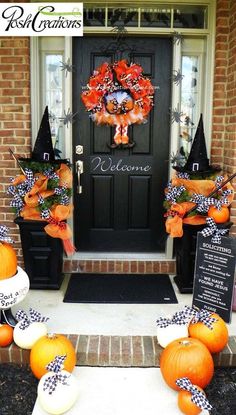 a front door decorated for halloween with pumpkins and decorations