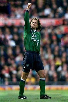 a soccer player raising his arms in the air