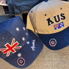 two hats with the words australia and an australian flag on them sitting next to each other