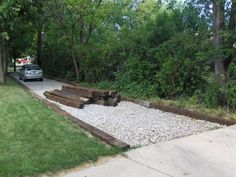 a car parked on the side of a road next to a pile of wood and gravel