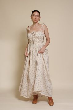 Brand: In Loom Floral print maxi dress with tie straps and side pockets. ♡ Details Color: Vintage Cream Tie straps Lightly smocked bodice Side pockets Partially lined 97% Cotton, 3% Polyester | Lining: 100% Rayon Hand wash recommended Size & Fit Model info: Height 5'3"| Bust 32"| Waist 25"| Hips 34" Model is wearing a size small Fit: Relaxed fit Stretch: Bodice of dress has stretch Measurements: S: Bust 31" | Length 51.5" M: Bust 33" | Length 52" L: Bust 35" | Length 53" Smocked Bodice Maxi Sundress With Ruffled Straps, Daywear Maxi Dress With Knotted Spaghetti Straps, Casual Maxi Dress With Adjustable Straps For Garden Party, Beige Maxi Dress With Adjustable Straps For Day Out, Daywear Sundress With Adjustable Ruffled Straps, Brunch Maxi Dress With Square Neck And Adjustable Straps, Cotton Tie-back Maxi Sundress, Sundress Maxi Dress With Adjustable Straps, Ruffled Strap Sundress With Adjustable Straps For Daywear