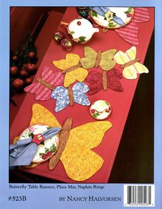 an image of a table setting with butterfly appliques on red placemats