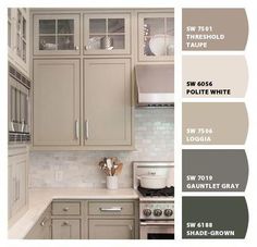 a kitchen with gray cabinets and white counter tops in shades of grey, brown, and beige