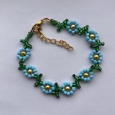 Pretty sunflower design  encompassed in anklet  Blue and green glass seed beads Yellow glass pearl bead centers finished with lobster clasp & extension chain and charm Length option available  shipping Free delivery on all uk orders International is by Airmail,please see listings for time scale If anything is not to your complete satisfaction I would appreciate to be given the opportunity to put it right BEFORE feedback is left. Any problems: Please send me a message before opening a case as mos Summer Flower Shaped Beaded Chain Jewelry, Green Beaded Bracelets For Summer, Green Beaded Chain Bracelets For Summer, Blue Flower Beaded Bracelets For Summer, Blue Beaded Chain Anklets As Gift, Blue Beaded Chain Anklets For Gift, Green Beaded Anklets With Round Beads, Green Beaded Anklets For Summer, Green Beaded Summer Anklets