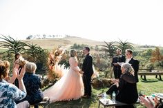 a couple getting married in front of an outdoor ceremony