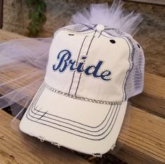 "Custom Bride Hat for Baseball Bachelorette Party or Bridal Shower- Customized to match her favorite team font and colors! I can match any team Makes a perfect gift for Bride! My Baseball theme Bride caps come with veil and customized in her favorite Baseball Team Colors. Perfect accessory to wear to a bachelorette party/bridal shower at a Baseball Game! Team Bride Hats also available message me for package deals@ OTHER BRIDE HAT STYLES AVAILABLE CLICK HERE https://www.etsy.com/shop/CapsbyKari?s Personalized White Trucker Hat For Sports Events, Personalized White Baseball Cap For Sports Events, White Personalized Hat For Baseball Season, Customizable White Trucker Hat For Sports Fans, Customizable White Hats For Fan Gear, Baseball Bachelorette Party, Baseball Bachelorette, Bride Hats, Bachelorette Party Hat