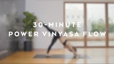 a woman doing yoga in front of a window with the words 30 - minute power vinyasa flow